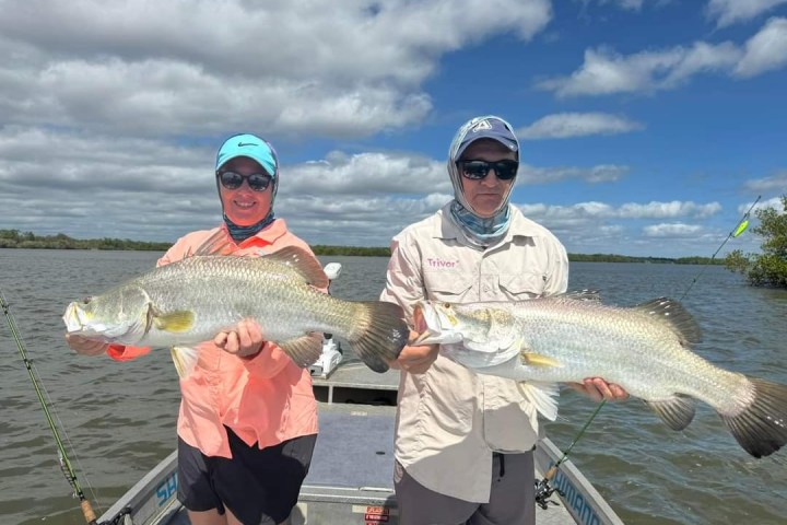 a person holding a fish in the water