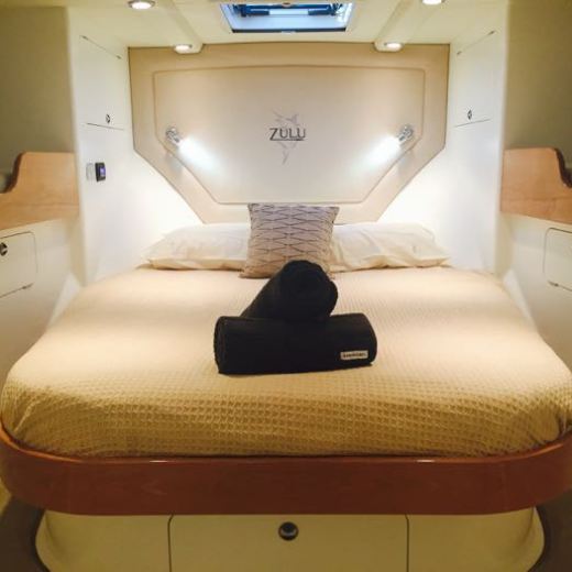 a bedroom with a bed and desk in a room