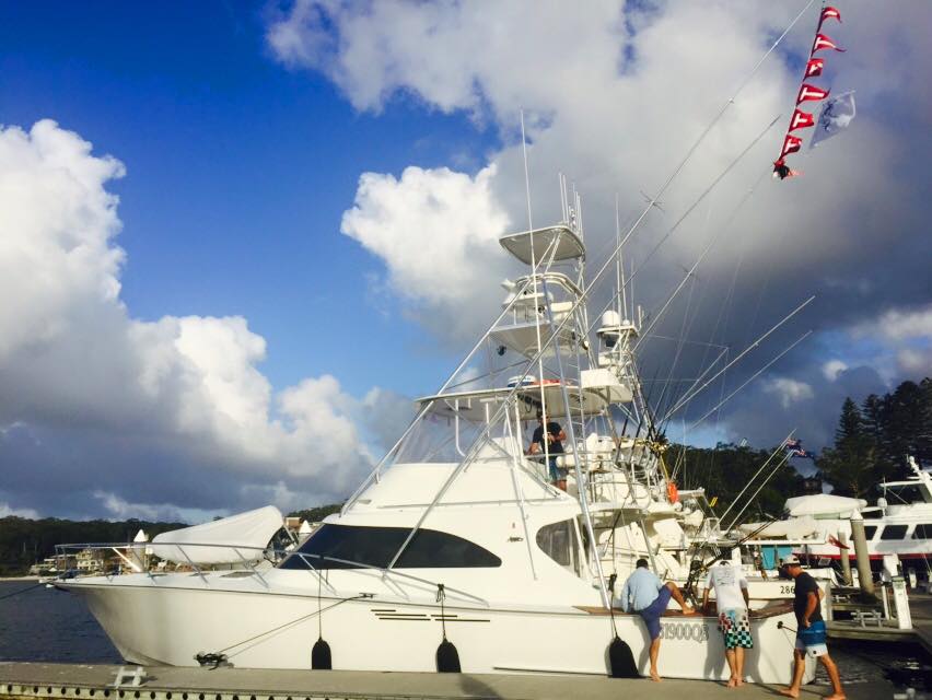 a group of people flying kites on a boat